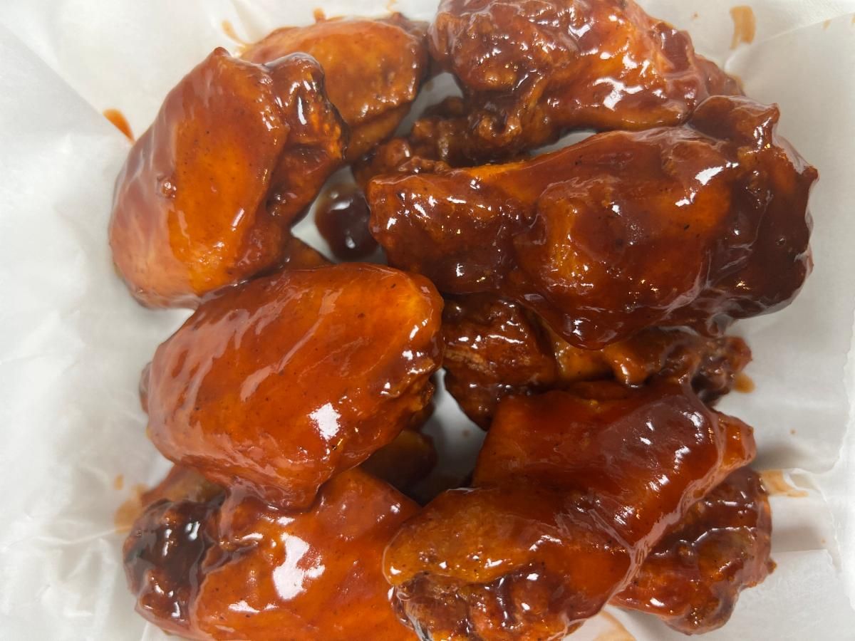 Sauced wings glazed in a sticky red-orange sauce