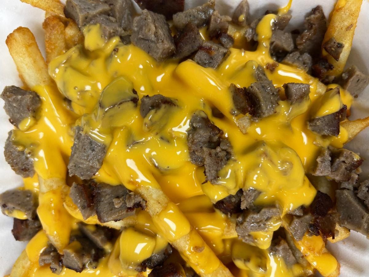 Fries covered in cheese sauce and chopped gyro meat
