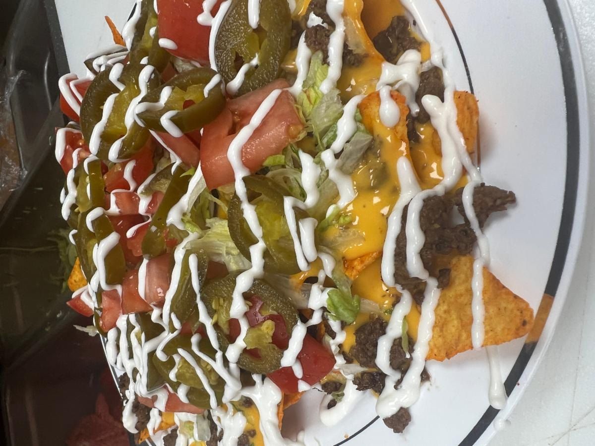 Nacho Supreme with ground beef, cheese, jalapeños, tomato and sour cream
